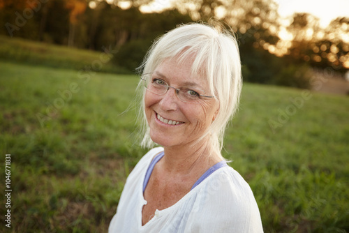 Smile, happy and portrait of senior woman with confidence for retirement, vacation and outdoor exploring. Nature, mature person and relax in New York park for holiday, tourism and health or wellness