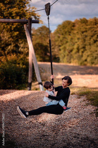 Mother and son enjoying a fun zipline ride outdoors photo