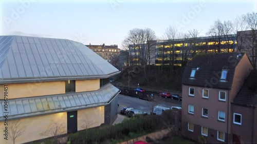 Drone footage of Edinburgh, Scotland, showcasing residential buildings and Arthur’s Seat in the background. The clip highlights urban architecture and the natural landscape at dusk.