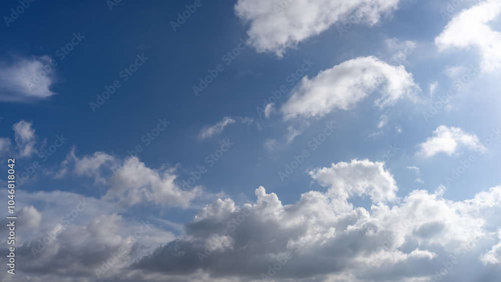 Tranquil Sky with Fluffy White Clouds Against a Bright Blue Horizon Tranquil Sky with Fluffy White Clouds Against a Bright Blue Horizon
