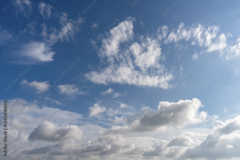Serene Blue Sky with Fluffy White Clouds Under Natural Light Serene Blue Sky with Fluffy White Clouds Under Natural Light