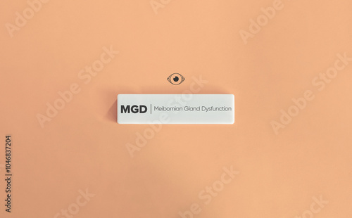 Meibomian Gland Dysfunction (MGD) Banner Image. Dry Eye Icon and Text on Block Block Letter Tile on Dusty Pink Background. Minimal Aesthetic. photo