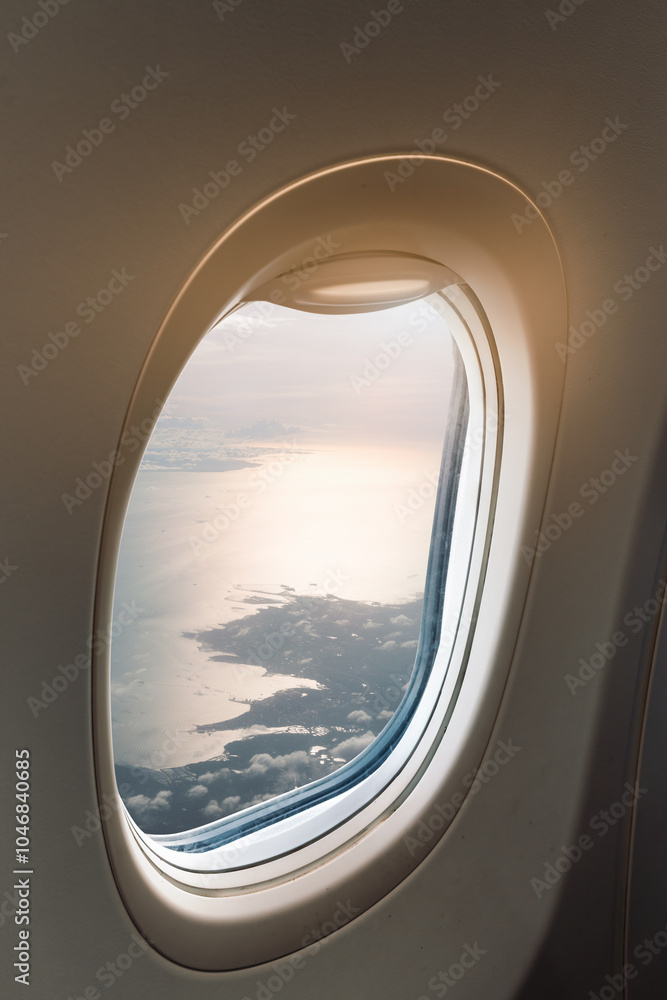 Fototapeta premium Serene Aerial View Through Airplane Window Showcasing Landscape and Clouds