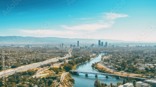 Aerial view of the river in Los Angeles with industrial areas on one side and residential neighborhoods on the other,