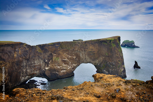 View of the rocky arch from Dyrhólaey viewpoint, Iceland photo