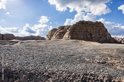 Gravel road square and Yardang landform mountain nature landscape under blue sky. Nature background. photo