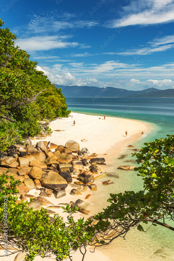 Picturesque tropical golden Nudey Beach with turquoise water on Fitzroy Island. It is a continental island southeast of Cairns, Queensland, Australia.