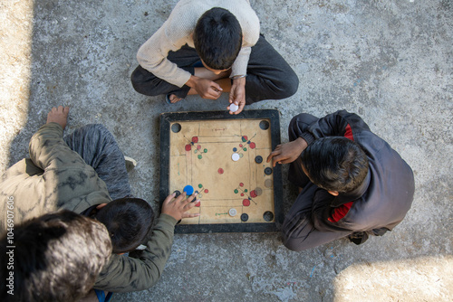 Indian village boys focus intently on a carrom board while playing together in a courtyard, surrounded by pastel-colored walls and a calming atmosphere.