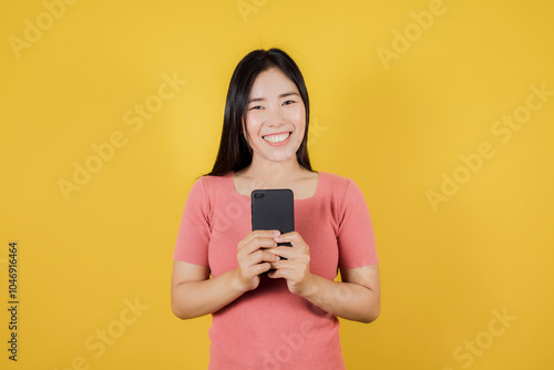 Portrait of smiling Asian woman using a smartphone