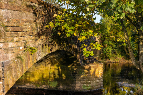 Old sandstone Lugar Bridge carrying Mill Street over Lugar Water in Ochiltree East Ayrshire photo