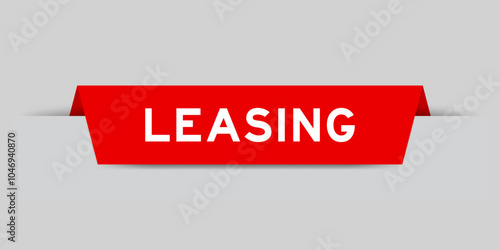 Red color inserted label with word leasing on gray background