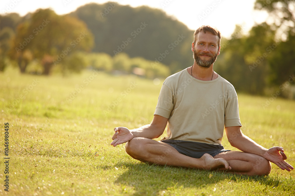 Fototapeta premium Meditation, lotus pose and portrait of man in nature for relax, calm and grounding exercise in morning. Health, peaceful and male person in padmasana for outdoor flexibility, balance and mindfulness.