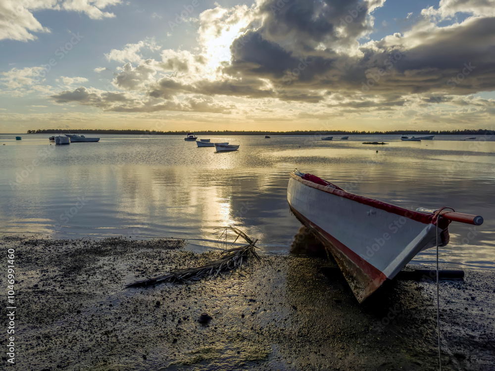 Obraz premium Fishermen's boat at water's edge 