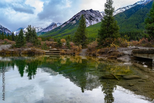 Vista view at Inkpots ponds hinking trail via Johnston Canyon showing Mystic peak all the way to Noetic Peak, clear water and snowcap mountains in the background during Autunm at Banff National Park photo