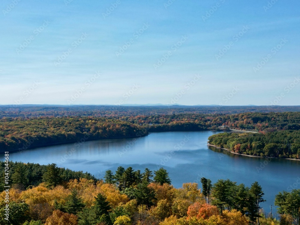 Aerial view of a tranquil lake with autumn foliage. Aerial view of a tranquil lake with autumn foliage.