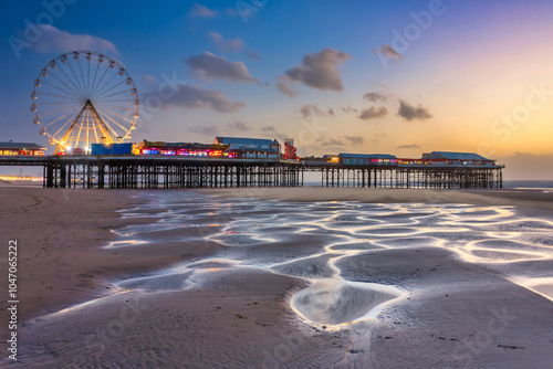 Beautiful landscape of Blackpool beach with illuminated pier and Ferris wheel at sunset. United Kingdom photo