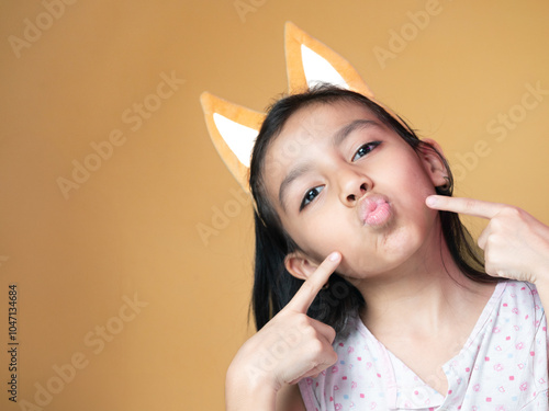 Portrait White Girl with Cat Ears Yellow Background kiss
