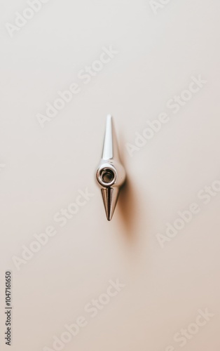 Closeup of a sharp metal pen tip on a light background