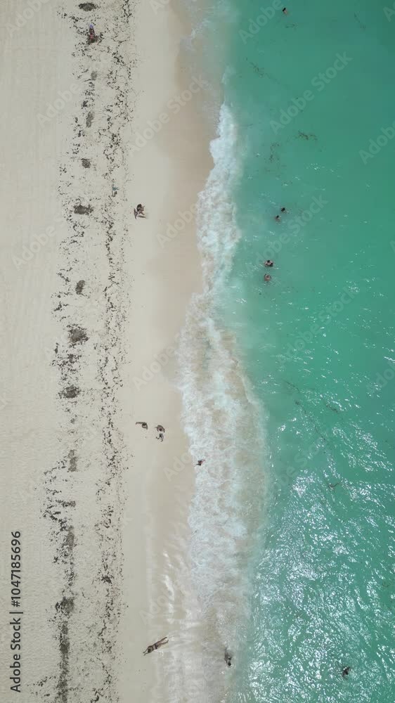 Aerial Top view of a transparent blue sea with beautiful waves at sunny day in summer. Tropical landscape from the air of ocean with azure water, sandy bottom at sunset. Cancun, Mexico. Aerial Top view of a transparent blue sea with beautiful waves at sunny day in summer. Tropical landscape from the air of ocean with azure water, sandy bottom at sunset. Cancun, Mexico.