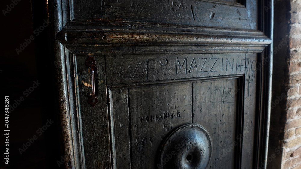 Wooden door in a monastery with a inscription on it Wooden door in a monastery with a inscription on it
