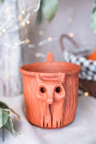 Rustic Clay Cup with Carved Forest Goblin Face, Evoking Folk Legends and Mystical Forest Spirits. Vertical