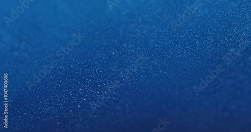 A deep blue background covered with densely packed shimmering particles, creating a textured surface with DOF. ideal for tech presentations, futuristic visuals, or modern digital product backgrounds.