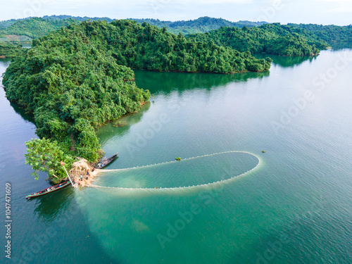 An aerial view shows local tribal people fishing with boats and big colorful nets in Kaptai Lake in Rangamati, Bangladesh, on October 22, 2024. photo