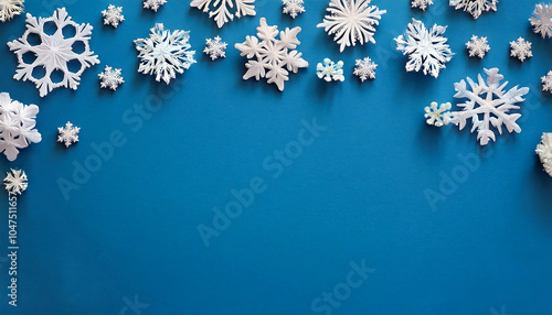 Snowflakes on blue paper make a simple winter design for a holiday greeting card with e_1(636)