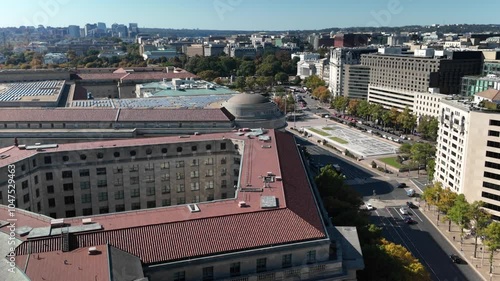 Aerial view of Washington DC showcasing White House, EPA, buildings, a large plaza, trees, and streets with cars. The image captures a blend of urban and natural elements. photo