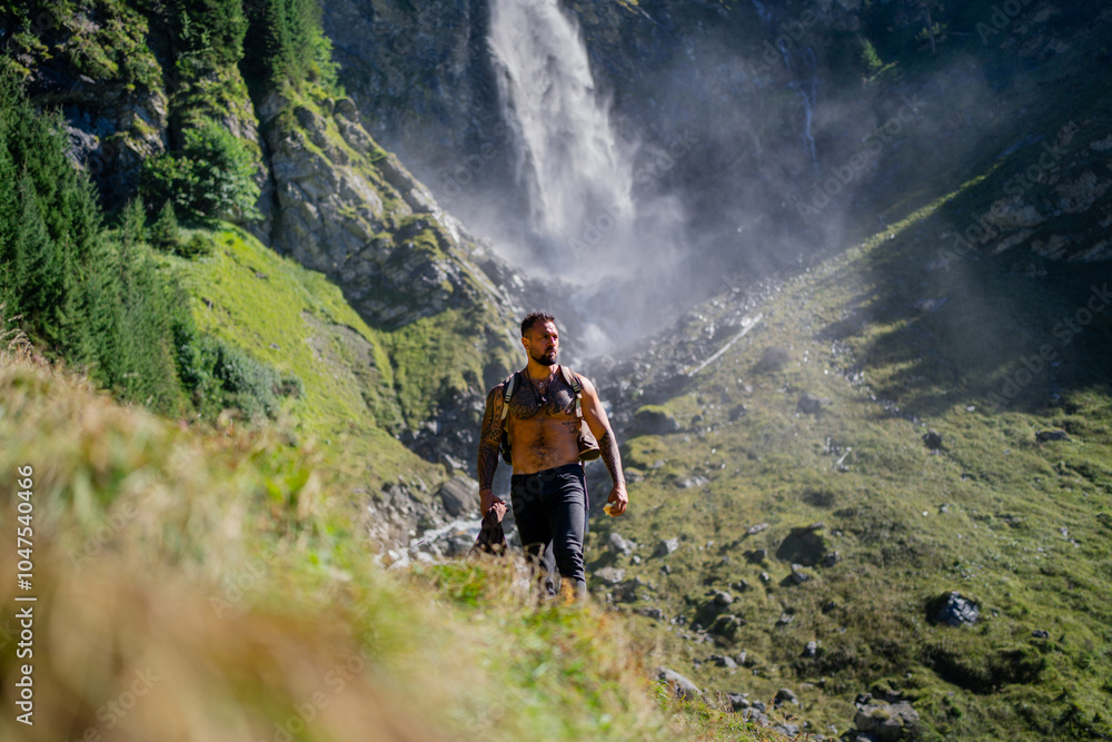 Man hiker on summer vacation. Tourist hiker with muscular torso. Strong Hispanic Tourist Hiker outside. Hiker walking near the waterfall. Traveling on nature. Carefree hiking. Hiking on mountain. Man hiker on summer vacation. Tourist hiker with muscular torso. Strong Hispanic Tourist Hiker outside. Hiker walking near the waterfall. Traveling on nature. Carefree hiking. Hiking on mountain.