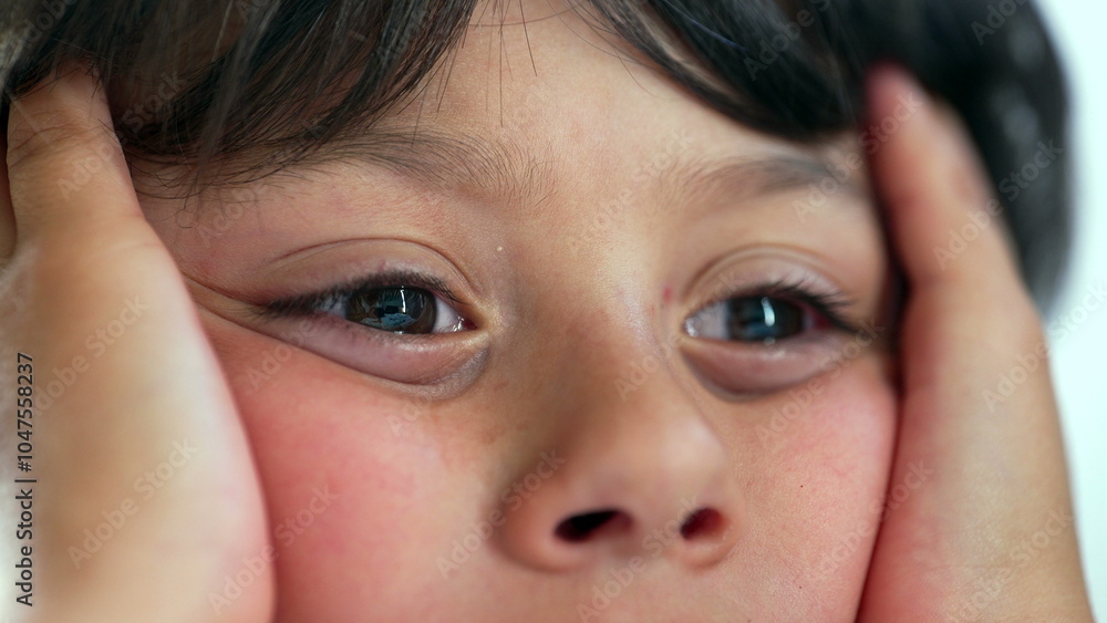 Child pressing face into hands with a distant gaze, lips slightly parted, portraying a sense of wonder and thoughtfulness while sitting quietly, highlighting raw childhood emotion Child pressing face into hands with a distant gaze, lips slightly parted, portraying a sense of wonder and thoughtfulness while sitting quietly, highlighting raw childhood emotion