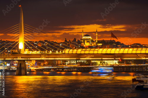 cityscape of Istanbul at night, Turkey, view to the Golden Horn Bay and architecture of city and a bridge for metro and Bosphorus shore against the sunset sky, a popular tourist destination