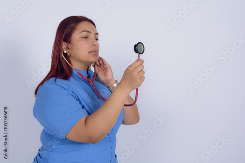 Medical specialist holding stethoscope with hand raised to the side making auscultation photo