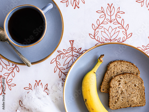 breakfast table with coffee bananas and toast photo