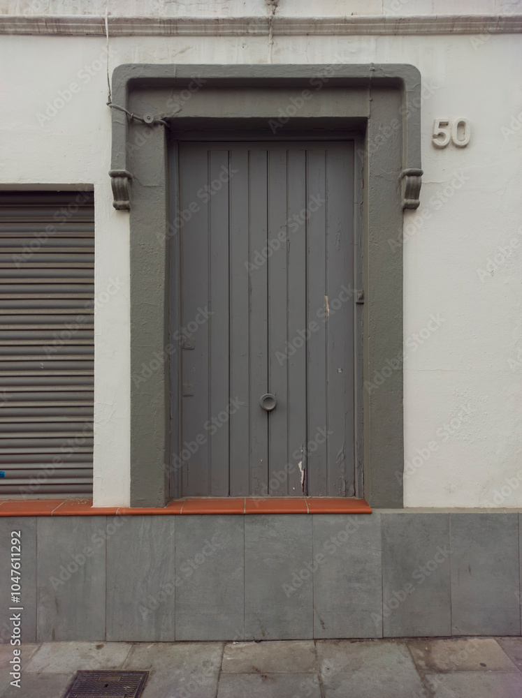 closed window with wooden shutters in the house, outside. closed window with wooden shutters in the house, outside.