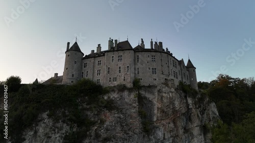 Discover Walzin Castle's enchanting beauty at twilight on the cliffside photo