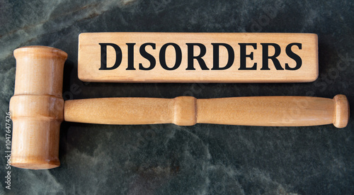 DISORDERS - word on wooden blocks on a green background with a judge's gavel photo