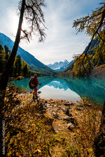 a tourist girl on the shore of the beautiful mountain lake Shavlinsky in Altai photo