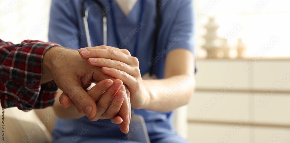 Fototapeta premium Caregiver supporting senior woman indoors, space for text. Home health care service