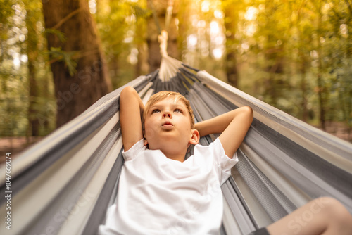 Bilde på lerret little carefree boy whistling while relaxing in hammock feeling happy in nature