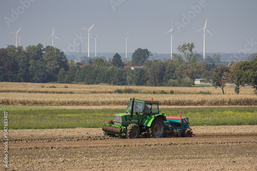 Farmer in tractor seeding soybeans at industrial agricultural farm