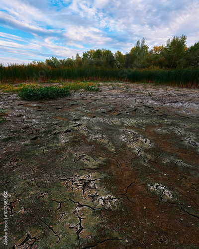 a dried-up riverbed, sky and clouds