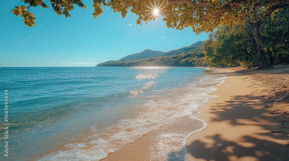 A beautiful beach with white sand and turquoise water. The sun shines through the branches of trees. A beautiful beach with white sand and turquoise water. The sun shines through the branches of trees.