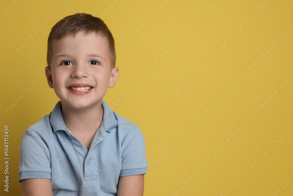 Portrait of cute little boy on yellow background, space for text Portrait of cute little boy on yellow background, space for text