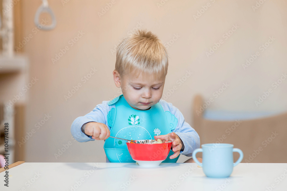 Baby food. Eating. Feeding the baby. A cute kid eats on his own with a spoon. Healthy eating. Family and children. Baby food. Eating. Feeding the baby. A cute kid eats on his own with a spoon. Healthy eating. Family and children.
