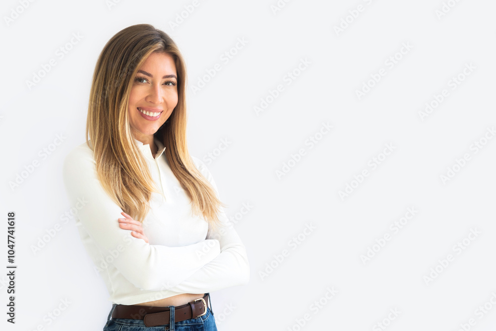 Portrait of a young Caucasian woman with pleasant smile and crossed arms isolated on white wall Portrait of a young Caucasian woman with pleasant smile and crossed arms isolated on white wall