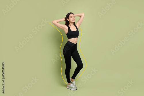 Happy young woman with slim body posing on light green background. Lines around repeating her figure