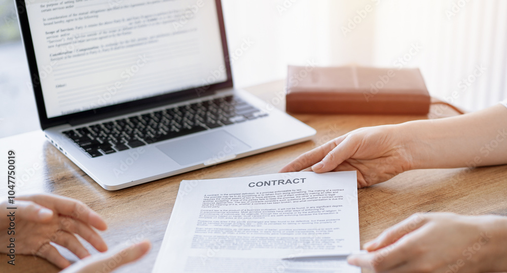 Obraz premium Businesswoman lawyer pointing into contract special points admitting something for colleague or client at the wooden desk in office. Business people teamwork and partnership, meeting concept