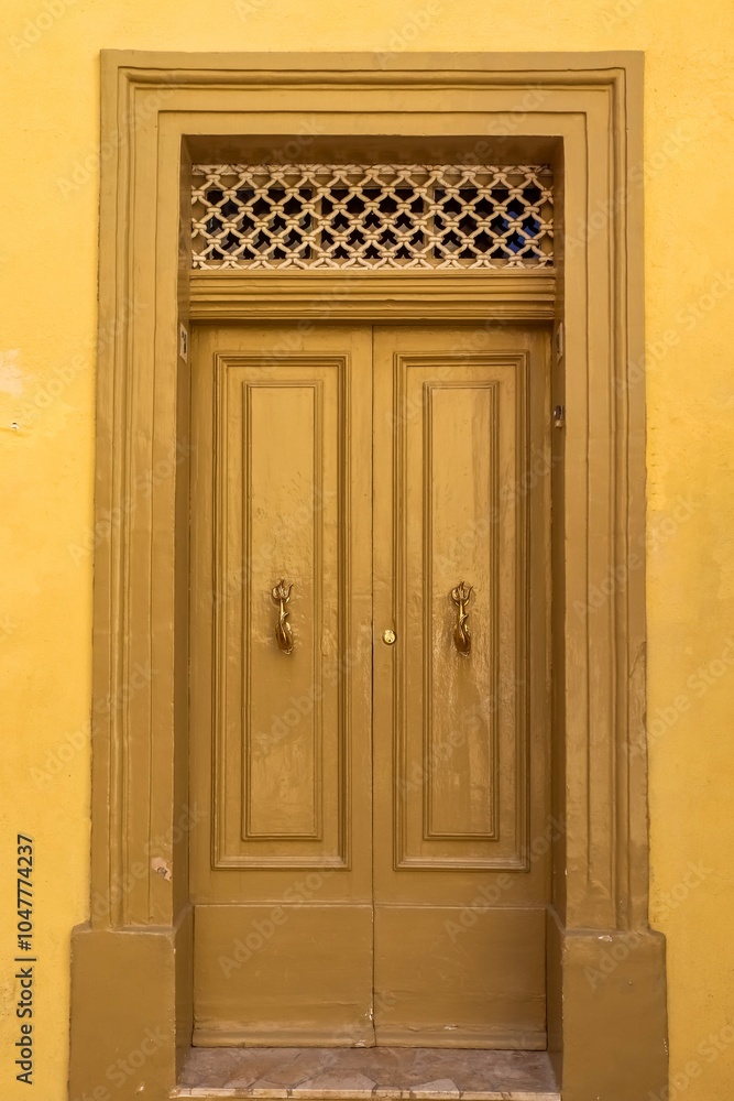 An old wooden blue door in a Mediterranean setting in a historic town in Italy. An old wooden blue door in a Mediterranean setting in a historic town in Italy.