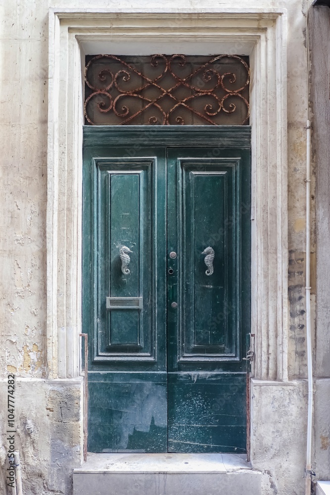 An old wooden blue door in a Mediterranean setting in a historic town in Italy. An old wooden blue door in a Mediterranean setting in a historic town in Italy.